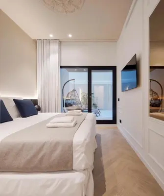 a hotel room with two beds and a television at Blanq Ruzafa in Valencia