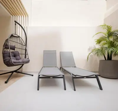 two chairs and a chair in a room at Blanq Ruzafa in Valencia