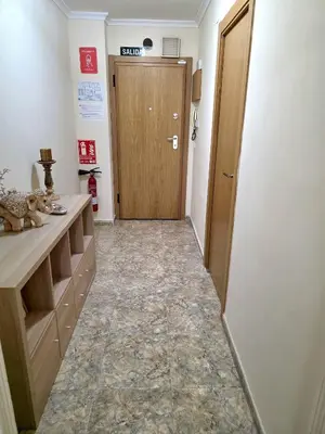a hallway with a door in a room with a tile floor at Vivienda Particular Cerca de Valencia in Paterna