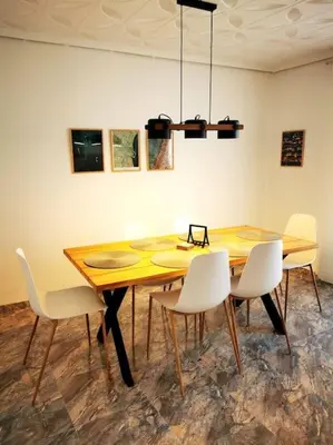 a dining room table with white chairs around it at Great 4 bedrooms apartament in Puerto de Sagunto - Full Apartment - 120m2 in Puerto de Sagunto