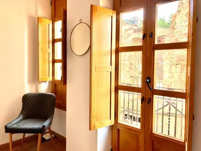 a room with a door and a chair and a window at Sagunto Castillo 17 in Sagunto