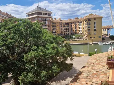 a view of a building and a body of water at Port Saplaya 3 habitaciones Valencia in Port Saplaya