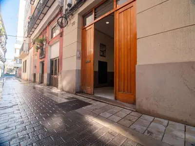 an empty alley with wooden doors on a building at MD Iturbi Jardin Turia in Valencia