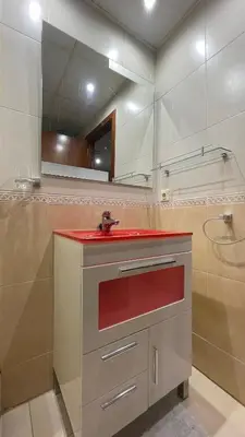 a bathroom with a red sink and a mirror at Work and Rest Away From Home in Paterna