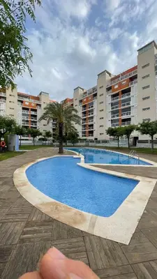 a swimming pool in front of some apartment buildings at Work and Rest Away From Home in Paterna