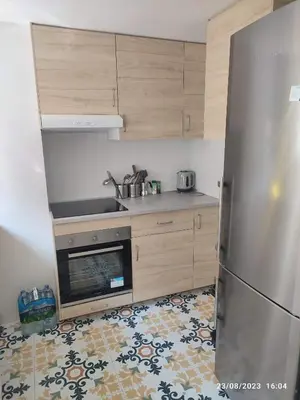 a kitchen with a stainless steel refrigerator and wooden cabinets at Arts & Sciences Rooms - Valencia Authentic Urban Parklife - VLC Urban Rental in Valencia