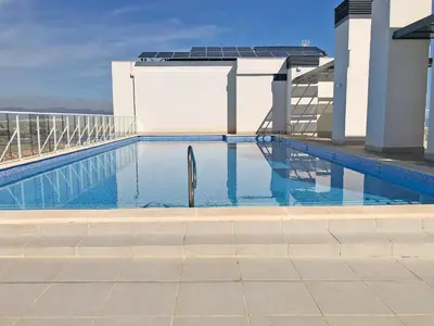 a swimming pool on the roof of a building at Global Vacacional, Apartamento con terraza y vistas al mar in Canet de Berenguer