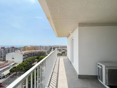a balcony with a view of a city at Global Vacacional, Apartamento con terraza y vistas al mar in Canet de Berenguer