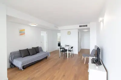 a living room with a couch and a table at Global Vacacional, Apartamento con terraza y vistas al mar in Canet de Berenguer