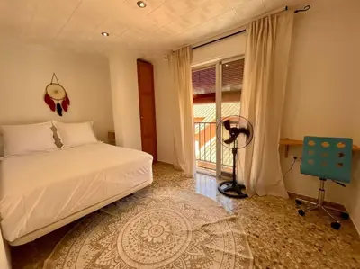 a bedroom with a bed and a window and a desk at Mountain Retreat with stunning terrace views in Pedralba