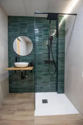 a bathroom with a shower with a sink and a mirror at Maritim 1 by Concept Flats in Valencia