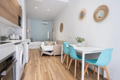 a kitchen and dining room with a table and chairs at Beach Apartments Valencia in Valencia