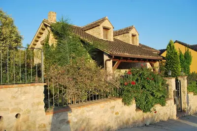 a house with a fence and plants on it at VILLA TAMARIT in Pedralba