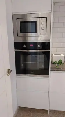 a stainless steel oven with a microwave in a kitchen at Santa Marta frente al mar in Cullera