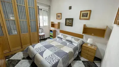 a bedroom with a bed in a room at flat family near center and jardin turia avenida del cid in Valencia