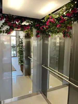 a row of elevators with pink flowers on them at Lumen Mare by SH Hoteles in Valencia