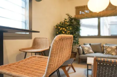 a living room with a wicker table and chairs at Lumen Mare by SH Hoteles in Valencia