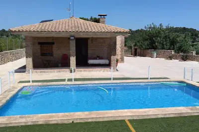a swimming pool in front of a house at Casa El Calderon in Chella