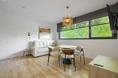 a living room with a couch and a table and chairs at Arena 20 Suites in Valencia