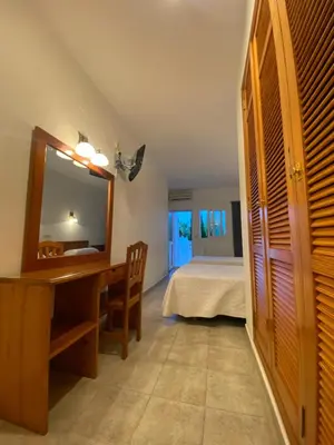 a bedroom with a bed and a desk and a mirror at Hostal Blayet - Hostal Automatizado in Valencia