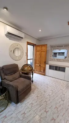a living room with a couch and a table at Bali Beach Puzol relax en la playa cerca de Sagunto y Valencia in Puzol