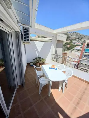 a patio with a white table and chairs on a balcony at GALEON, 10-75 Atico in Cullera