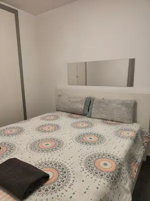 a bedroom with a bed with a floral bedspread at Mar i piscina Canet playa in Canet de Berenguer