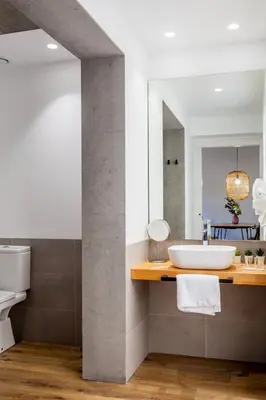 a bathroom with a sink and a mirror at Puerto Beach suites in Valencia