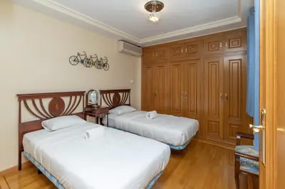 two beds in a room with wooden cabinets at GuestReady - A un paso del Mediterráneo in El Puig
