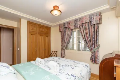 a bedroom with a bed and a window at GuestReady - A un paso del Mediterráneo in El Puig