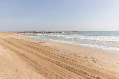 a sandy beach with the ocean in the background at GuestReady - A un paso del Mediterráneo in El Puig