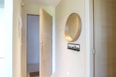 a bathroom with a mirror next to a door at Precioso apartamento en Canet Playa by Hometels in Canet de Berenguer