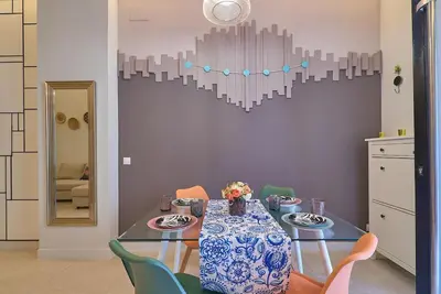 a dining room with a table and a heart wall at Invalencia - Buenos Aires Green Ruzafa Center in Valencia