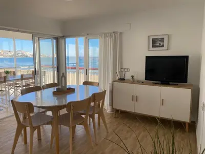 a dining room with a table and a television at Cara al mar in Cullera