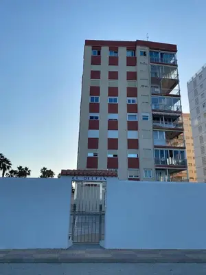 a tall building in front of a building at Cara al mar in Cullera