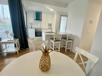 a kitchen with a table with a pineapple on it at VoraMar 3 Playa Puerto de Sagunto in Sagunto