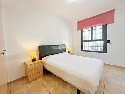 a small bedroom with a bed and a window at Global Vacacional, Apartamento con gran terraza en Canet in Canet de Berenguer
