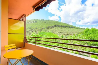 a balcony with a table and a view of a mountain at Un endroit accueillant avec vue à Jerica in Jérica