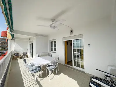a patio with a table and chairs on a balcony at Global Vacacional, Apartamento en primera línea de playa, Canet de Berenguer in Canet de Berenguer
