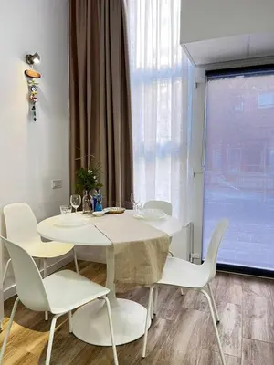 a dining room with a white table and white chairs at Rodrigues 15 in Valencia