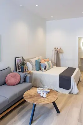 a bedroom with a bed and a couch and a table at VLC HOST - Cubells in Valencia