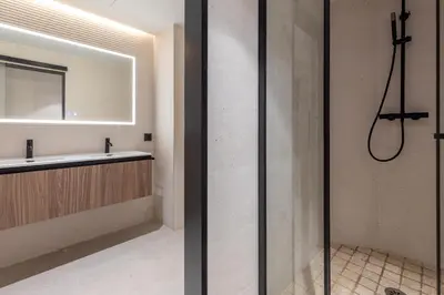 a bathroom with a shower and a sink at Calatrava by Alma Suites in Valencia