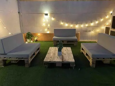 two beds and a table in a tent with lights at Valencia Ático playa Patacona. Parking incluido in Valencia