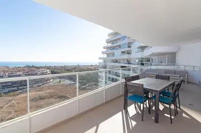 a balcony with a table and chairs and a view at Global Vacacional, Moderno apartamento con dos terrazas con vistas al mar y a la montaña in Canet de Berenguer