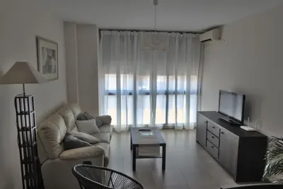 a living room with a couch and a tv at Coqueto apartamento de 3 habitaciones by Hometels in Puerto de Sagunto
