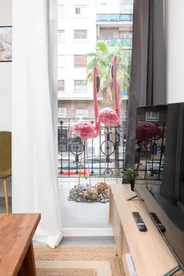 a room with two pink flamingos in front of a window at Belmar Apartments in Valencia