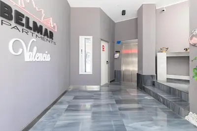 a hallway with a staircase and a sign on the wall at Belmar Apartments in Valencia
