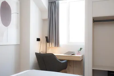 a bedroom with a desk and a chair next to a window at Aila II Hotel Boutique by SingularStays - Digital Access in Burjasot