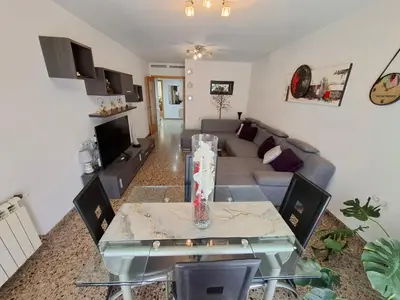 a living room with a couch and a table at Piso amplio de 3 habitaciones, calefacción, ascensor y parking in Burriana