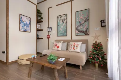 a living room with a couch and a christmas tree at Le Japonais de COUP DE COEUR APPARTEMENTS in Valencia